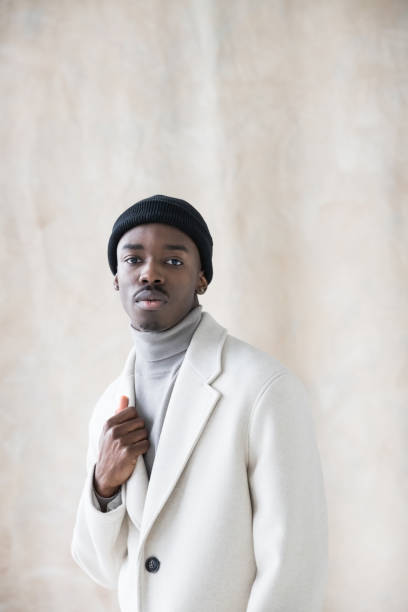 istock Elegant young man wearing white winter coat 1365602175