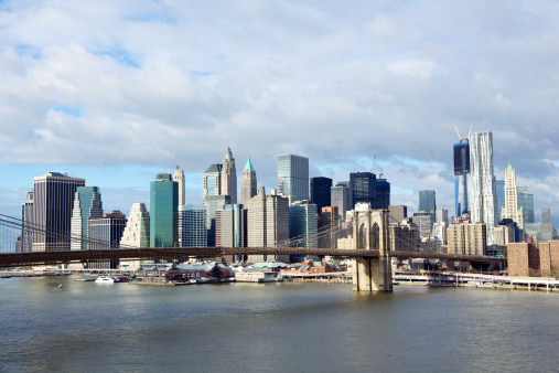 Brooklyn Bridge with lower Manhattan skyline in the morning over East River in New York City