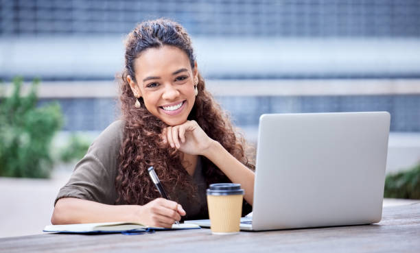 istock Shot of a young businesswoman using a laptop and notebook at work 1365603668