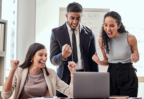 Work Cheering Shot If A Group Of Young Businesspeople Cheering While Using A Laptop ...