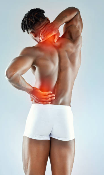 istock Studio shot of a muscular young man experiencing back pain 1365604387