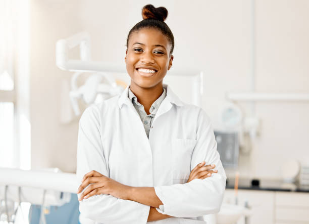 Shot of a young female dentist in her office Being a professional means being gentle laboratory coat stock pictures, royalty-free photos & images
