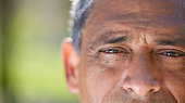 istock Cropped shot of an unrecognisable man looking into the camera during a day in the park 1365605322