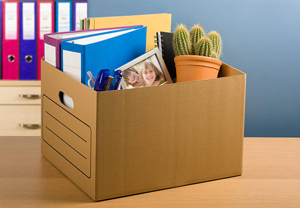 Made Redundant Box packed with personal items to convey being made redundant, fired. Includes a framed picture of two children for poignancy! Nikon D3 with tilt shift lens. cardboard box photos stock pictures, royalty-free photos & images
