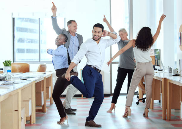 Shot of a group of businesspeople dancing in an office at work Showing off his moves career vitality stock pictures, royalty-free photos & images