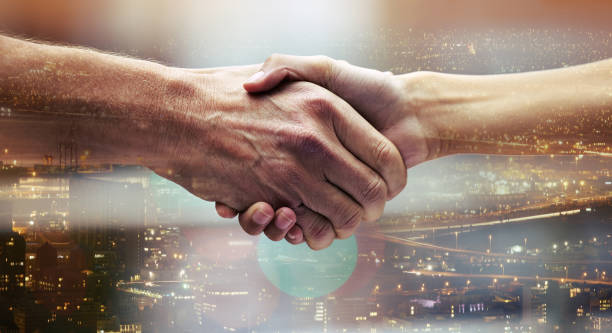 istock Shot of two unrecognizable people shaking hands 1365606062