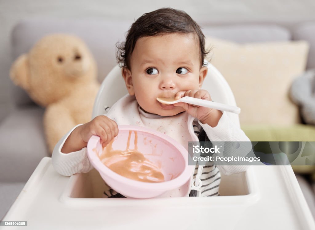 Shot of a baby eating a meal at home Baby girls are precious gifts Baby - Human Age Stock Photo