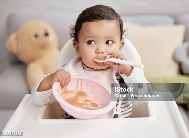 Shot Of A Baby Eating A Meal At Home Stock Photo - Download Image Now - Baby - Human Age, Eating, Food