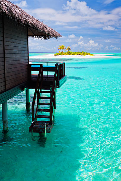 istock Over water bungalow with steps into blue lagoon 136560649