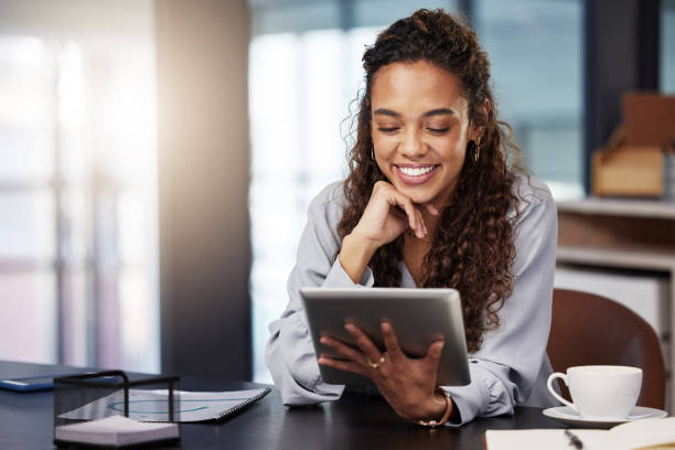 istock Shot of a young businesswoman using a digital tablet while at work 1365606633