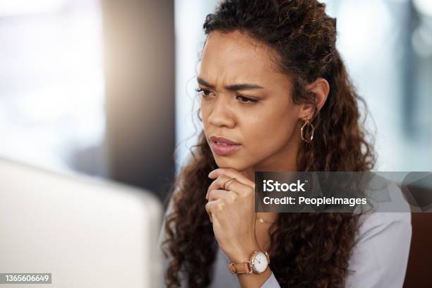 Shot Of A Young Businesswoman Looking Confused While Working On Her Computer Stock Photo - Download Image Now
