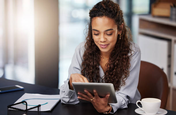 istock Shot of a young businesswoman using her digital tablet at work 1365606666