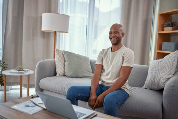 istock Shot of a young man using a laptop while working from home 1365606822