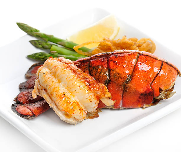 Grilled Lobster Tail Grilled Lobster Tail Served With Asparagus And Onion tail stock pictures, royalty-free photos & images