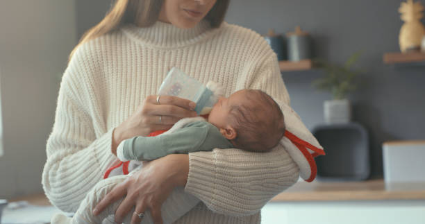 Shot of a mother feeding her newborn son stock photo