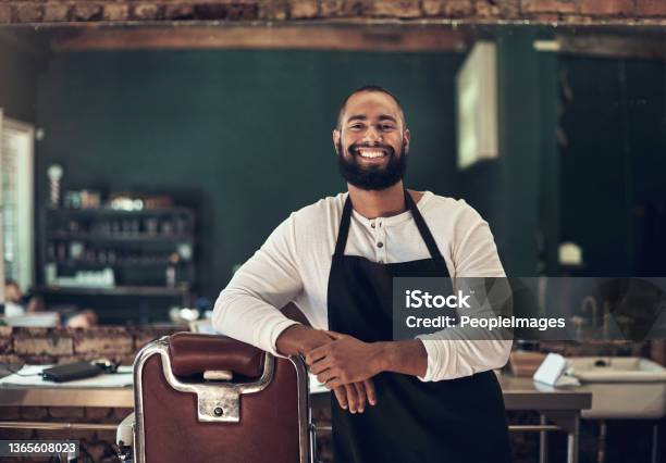 Shot Of A Handsome Young Barber Standing Alone In His Salon Stock Photo - Download Image Now