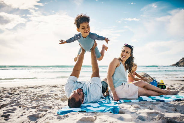 Shot of a man playing with his son on the beach