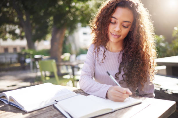 istock Shot of a young female student studying at a cafe 1365611016