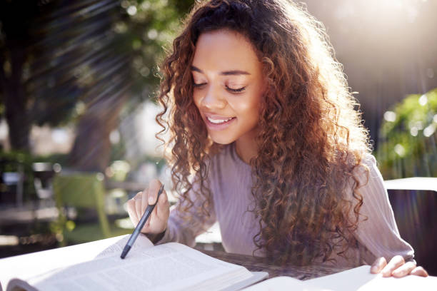 istock Shot of a young female student studying at a cafe 1365611062