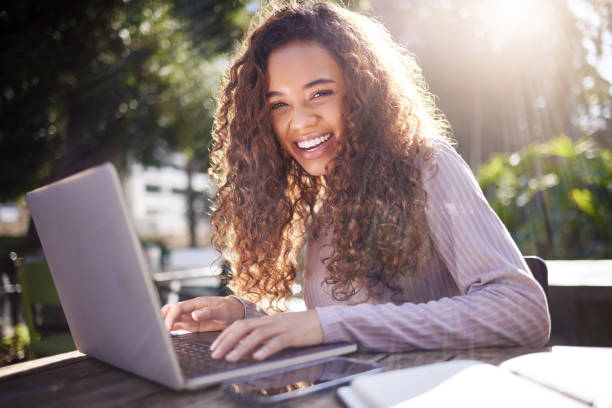 istock Shot of a young female student using a laptop while studying at a cafe 1365611071