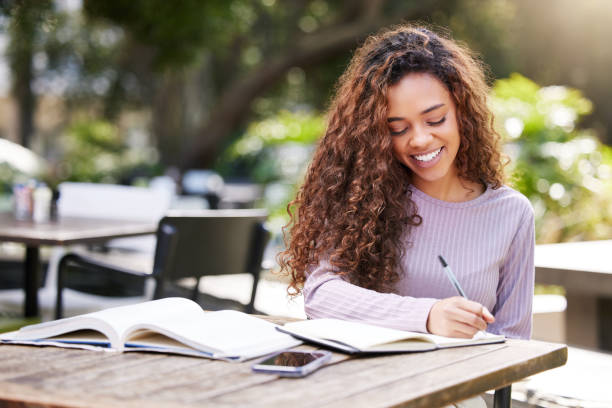 istock Shot of a young female student studying at a cafe 1365611080