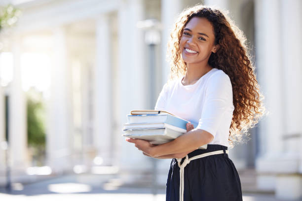 Shot of a young woman carrying her schoolbooks outside at college . textbook stock pictures, royalty-free photos & images