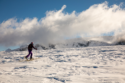 Snow-covered mountain range in a white fog. Stormy weather.