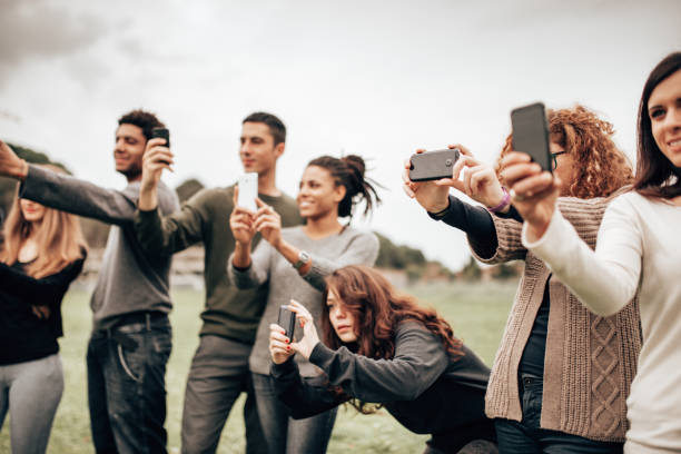 istock group of friends taking a pics outdoors 1365614683