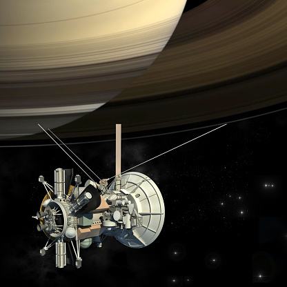An unmanned spacecraft similar to the Cassini Huygens orbiter satellite, passing the planet Saturn with the isolation path included in the 3D illustration. Elements of the image furnished by NASA.