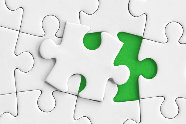 Open Puzzle one puzzle piece closes the puzzle. in the background the color green climate justice photos stock pictures, royalty-free photos & images