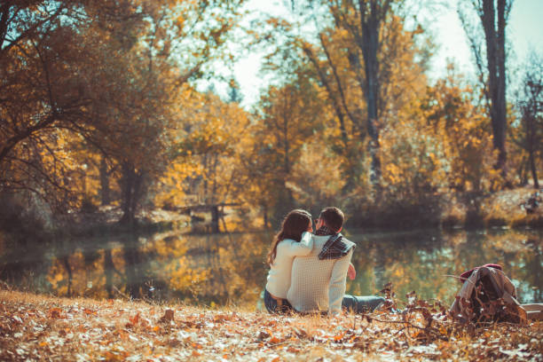 istock Stylish couple hugging near the river 1365616376