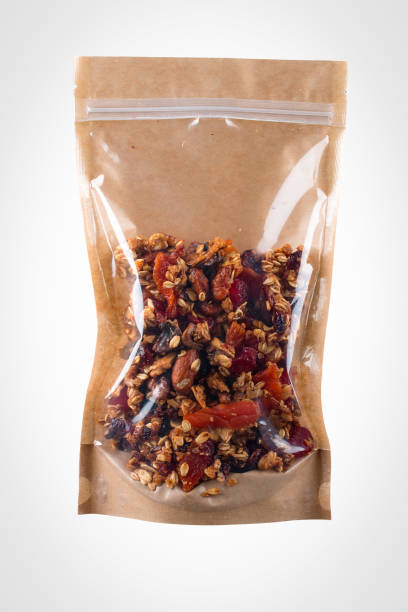 istock Dried berries and nuts packaged on a white background, vegan snack. 1365616823