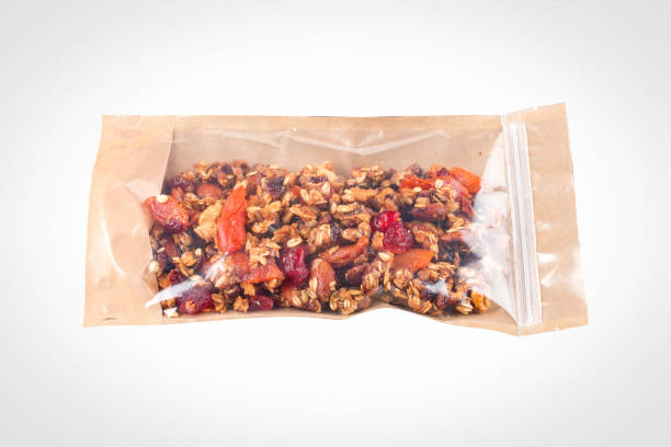 istock Dried berries and nuts packaged on a white background, vegan snack. 1365617480