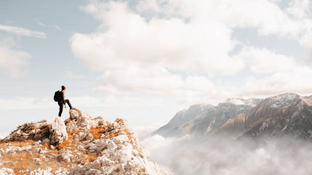 istock Male hiker looking at majestic mountain landscape 1365618204