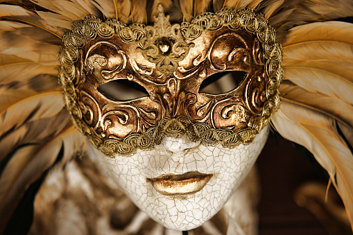 Store window decorated with Venetian style Carnival mask.  Spanish culture, tradition. Galicia, Spain.