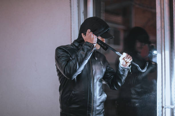 istock Man criminal robs the house 1365618737