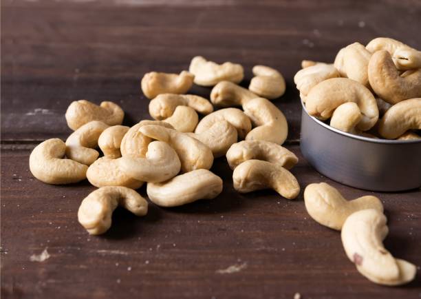 istock Cashew nuts isolated on wooden background 1365618813