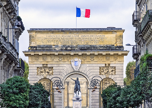 View of the equestrian statue of of Louis XIV and the triumphal arch in Montpellier, France.