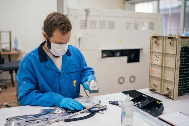 Man in factory working as quality control of machine parts