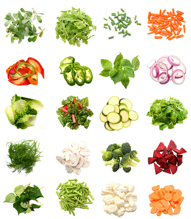 Variety of fresh vegetables chopped on white