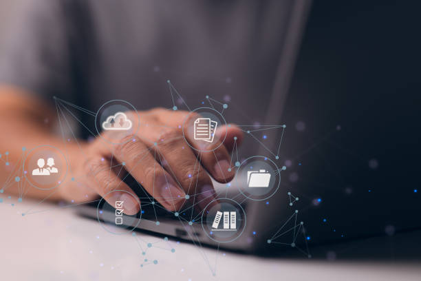 istock Businessman is using a computer to think about how to keep track of documents, how to keep records, how to keep files organized, how to access files, and more. 1365620184