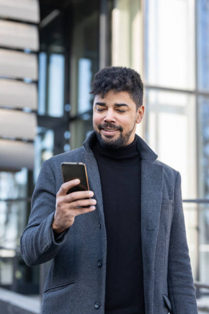 istock Confident businessman with mobile phone 1365620817