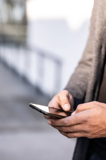 istock Confident businessman with mobile phone 1365621074