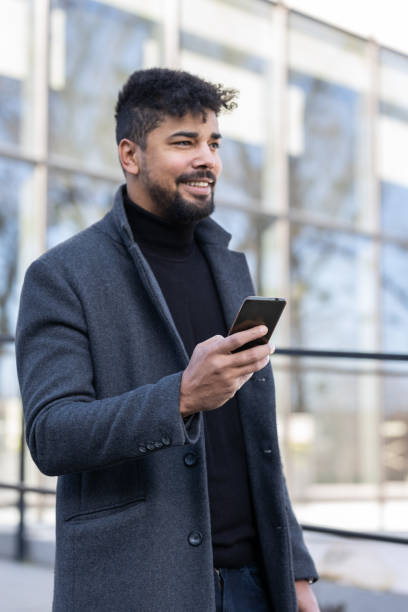 istock Confident businessman with mobile phone 1365621297