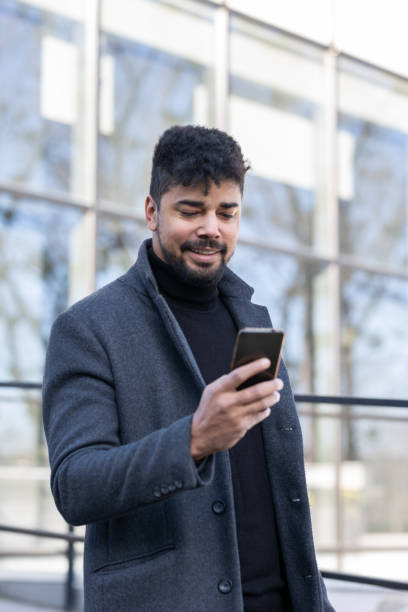 istock Confident businessman with mobile phone 1365621352
