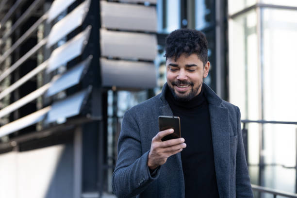 istock Confident businessman with mobile phone 1365621387