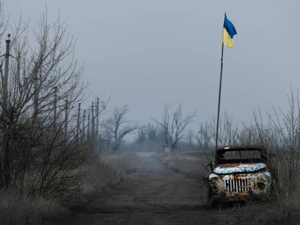 War in Eastern Ukraine - Frontline War in Eastern Ukraine, Donbas,  frontline positions near the town Avdiivka in Donetsk region - mud road between minefields  by military position 'Butovka' military invasion photos stock pictures, royalty-free photos & images
