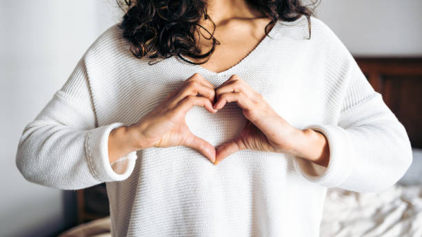istock Unrecognizable young woman making love gesture. Hands forming a cute heart shape. 1365626703