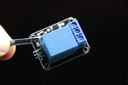 Single channel relay module isolated on black background, Electronic relay to control high voltage into low voltage