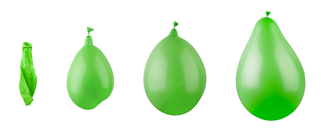Inflation stages of green balloons. Photographic concept.